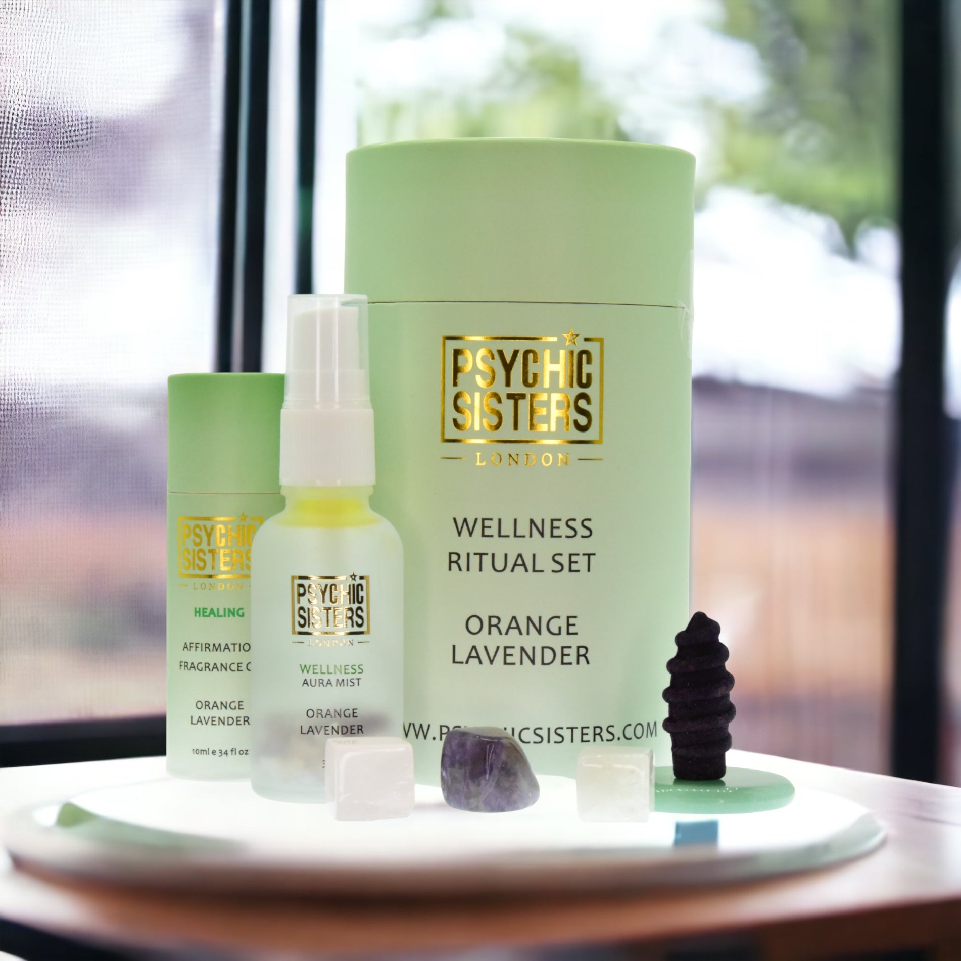 Psychic Sisters Wellness Ritual Set featuring orange and lavender aromatherapy and Reiki-energised crystals.